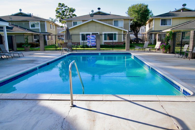 Beautiful looking swimming pool with sitting between villas of Huntington Gardens of Huntington Beach
