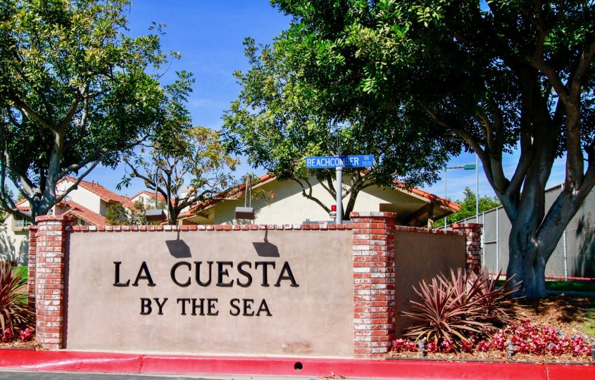In a sunny day a brick designed LA cuesta by the sea in the city of Huntington Beach, CA with trees but without any person.
