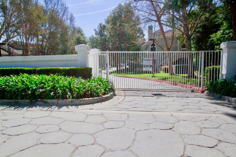 Gated residential community with well kept landscaping on a sunny and beautiful day in Huntington Beach California