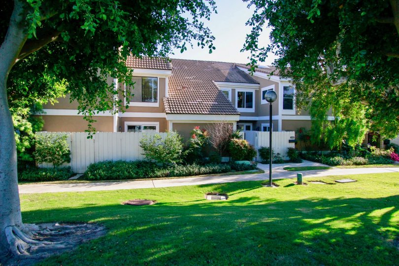 Town homes with ceramic tile roofing and shady trees in the Seagate community of Huntington Beach.