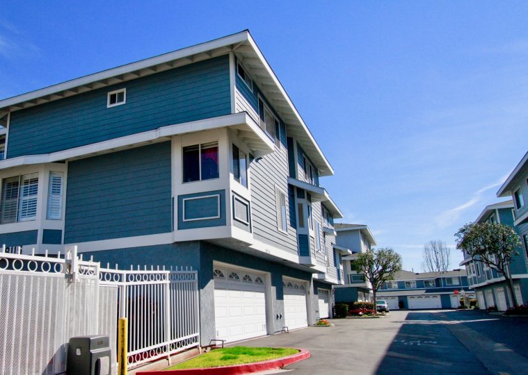 Seawind Cove street with homes on either side on a sunny day.
