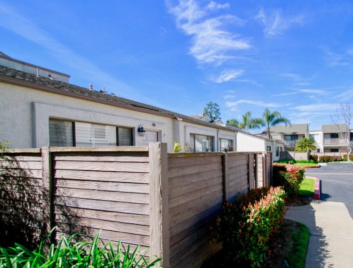 Fencing protects the front lawn of a beautiful home at Tamarack Village, Huntington Beach, California.