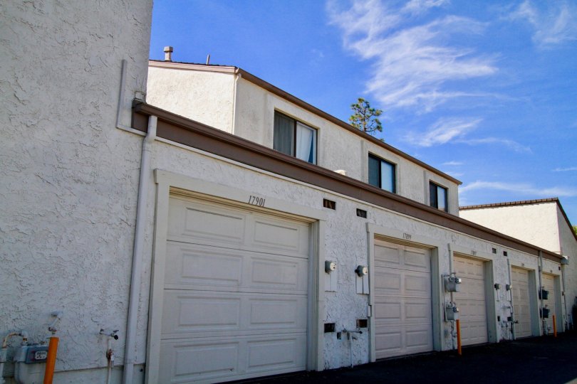 Row of Tamarack Village garages with apartments above on a sunny day.
