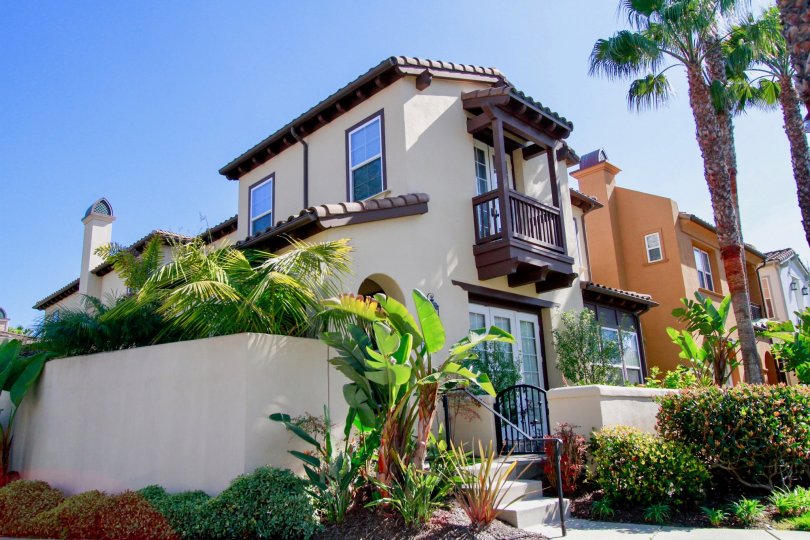 The Waterfront homes with a fence and palm trees.
