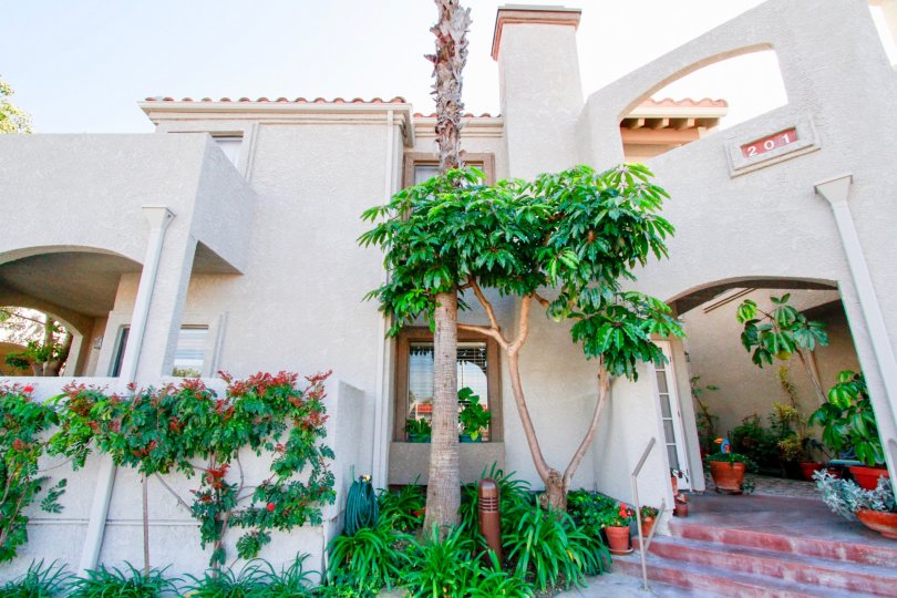 Nice entrance view of a villa with number and small trees around in Tiara De La Pacifica of Huntington Beach
