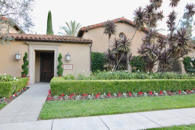 THE HOUSE ON EACH SIDE PLANTS WITH FLOWERS, BACKSIDE TREES ARE THERE IN IRVINE CITY