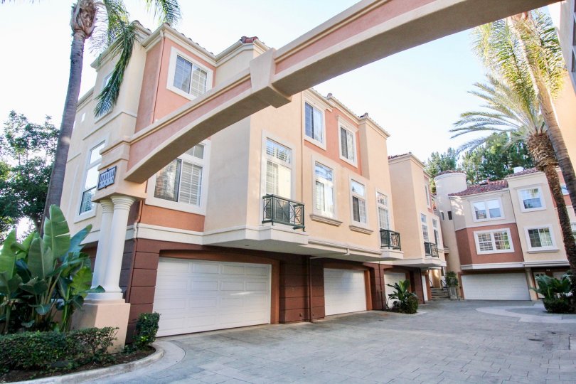 A large arch in front of the buildings in Corte Bella Villas