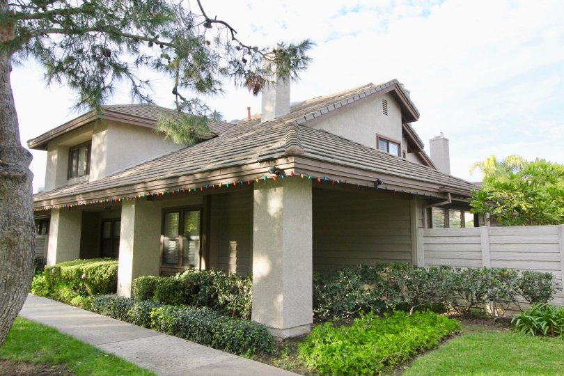 THE FRONT VIEW OF HOUSE WITH PLANTS, LAWN, TREE, PATHWAY ARE THERE, WHICH IS IN IRVINE CITY
