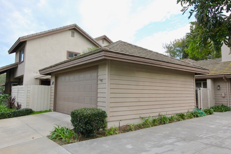 A sunny day in the area of Garden Estates, outside, garage, driveway, condo, trees, windows