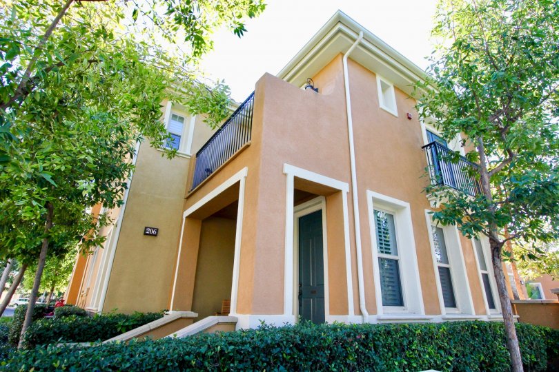 THE FRONT VIEW OF THE HOME WITH LOT OF TREES, PLANTS WHICH IS PLACED IN IRVINE
