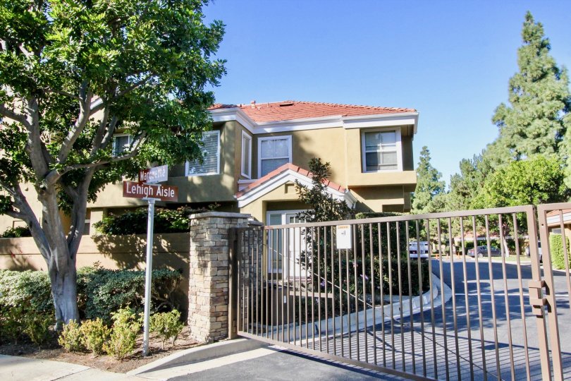 A closed gate protects a driveway entrance to the Oxford Court condos.