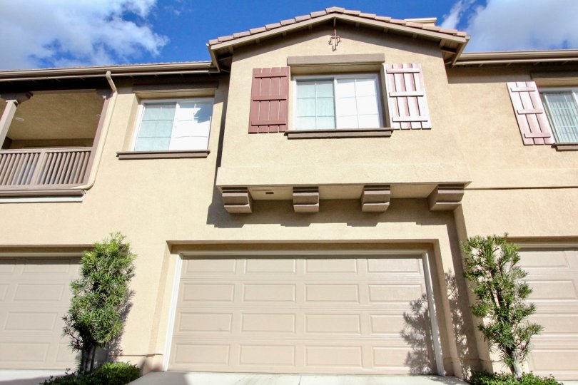 A two-storey residence in the Sheridance Place community with pink shutters and closed carport.