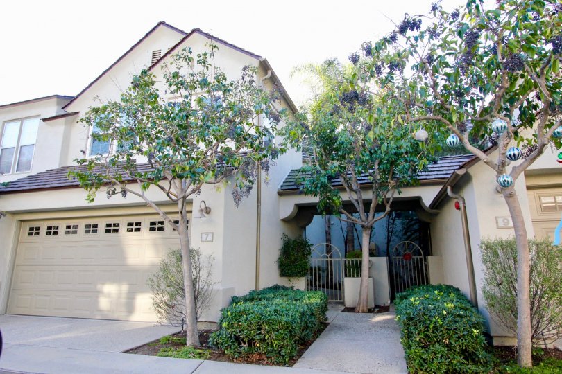 THIS IMAGE VIEWS THE FRONT OF HOME WITH SHED IN IRVINE, THAT SHOWS PLANTS AND TREES