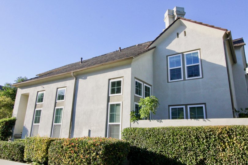 THIS IMAGE SHOWS THE SIDEVIEW OF HOUSE, LOT OF CROTON PLANTS ARE THERE IN IRVINE CITY