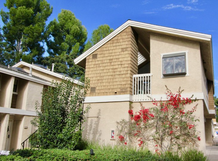 A sunny day in the area of The Lakes, outside, condo, balcony, roof, trees, sky