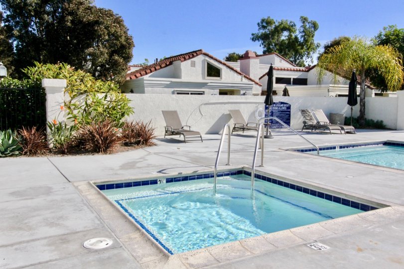 The Villas at RSJ swimming area features a large pool, spa and lounge chair area in Irvine California.