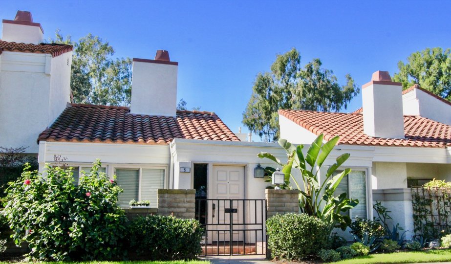 A street view of a home and landscaped yard on a sunny day at the Villas at RSJ