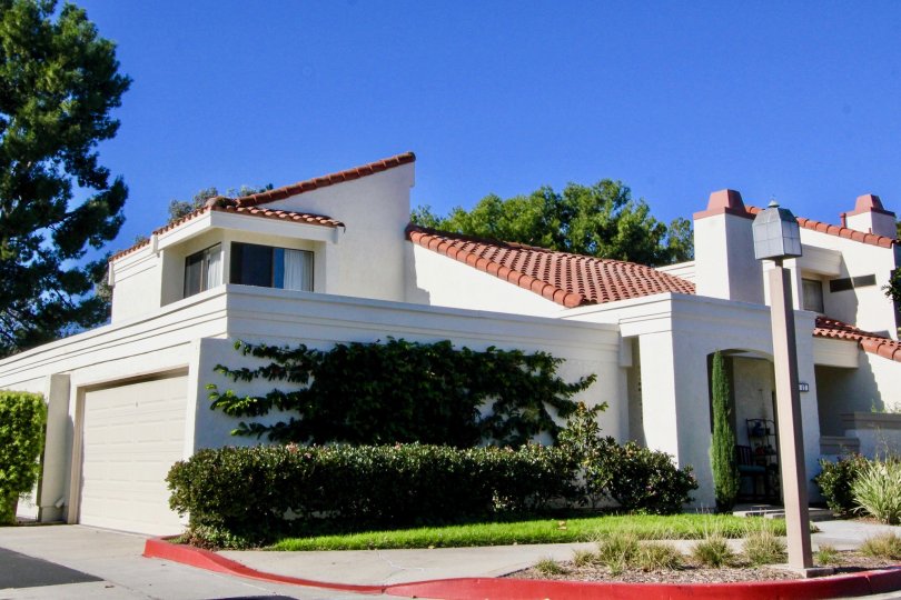 A traditional two-storey residence in the Villas at RSJ community with crazy pitched roofs.