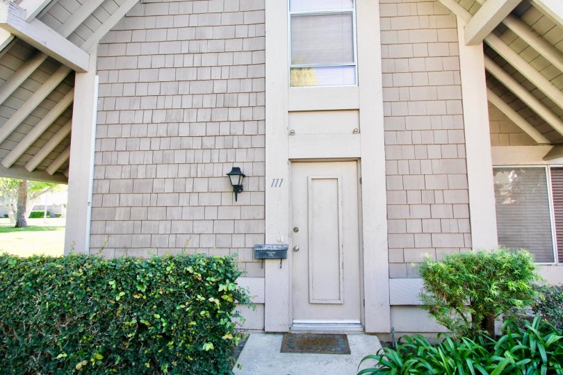 A sunny day in the area of Walnut Square, outside, door, mailbox, light, window, bushes