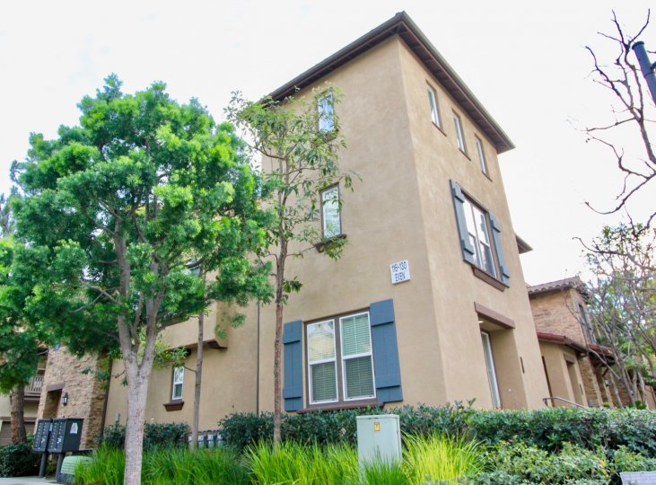 A two-and-a-half storey unit in Whispering Glen community with beige walls and blue shutters.