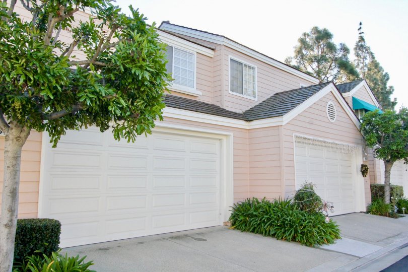 A two-storey unit in the Woodbridge Cove community with pinkish wooden cladding.
