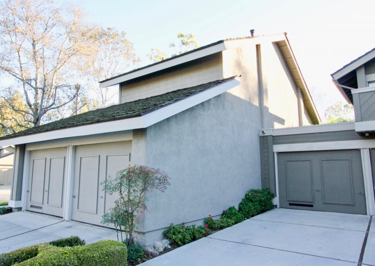 A corner view of a two-storey residence in the Woodbridge Crossing community with closed carports.