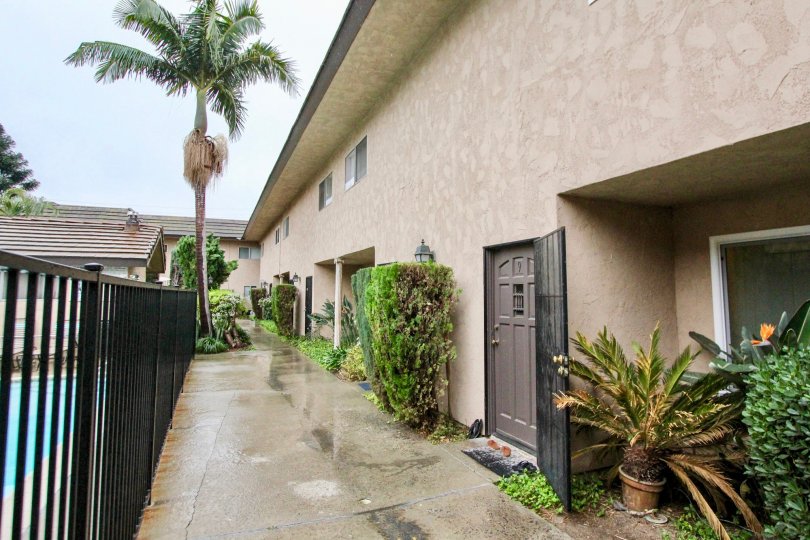 THIS IMAGE SHOWS THE CORRIDOR WITH LOT OF PLANTS LIKE CROTONS, TREES, ON THE LEFT SIDE SWIMMING POOL IS THERE LOCATED IN LA HABRA