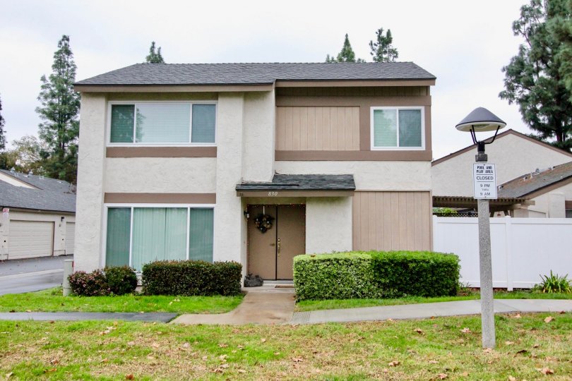 a pleasant day in the sunny hills village with a house that is numbered as 830 and has entrance door in the center