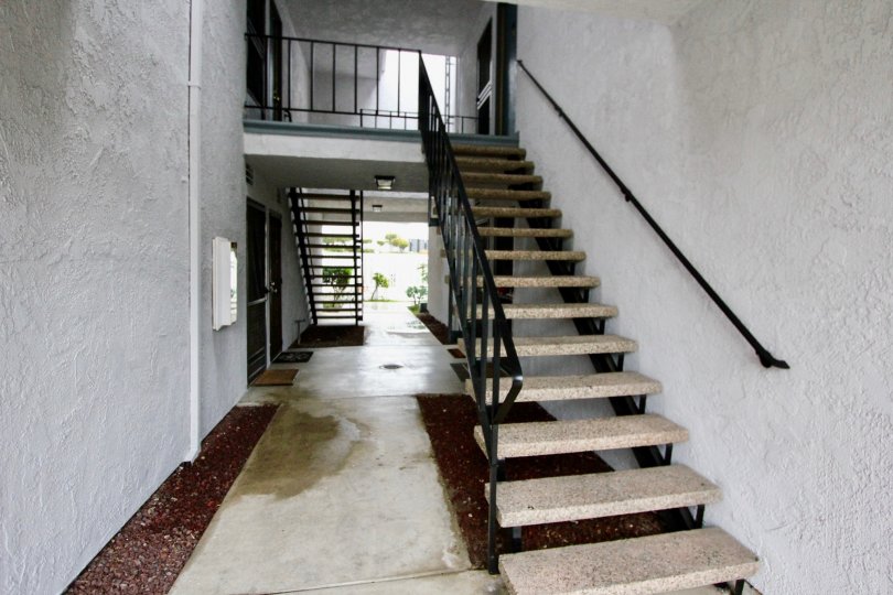 An exterior flight of stairs and entrances to several units in Woodlake Village