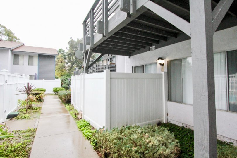 THE SIDE VIEW OF HOME LOCATED IN LA HABRA, THAT HAVE THE PATHWAY ON EACH SIDE SMALL PLANTS ARE THERE