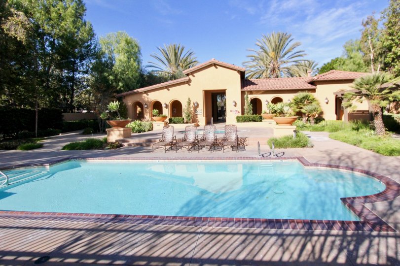 the house with swimming pool and some chairs