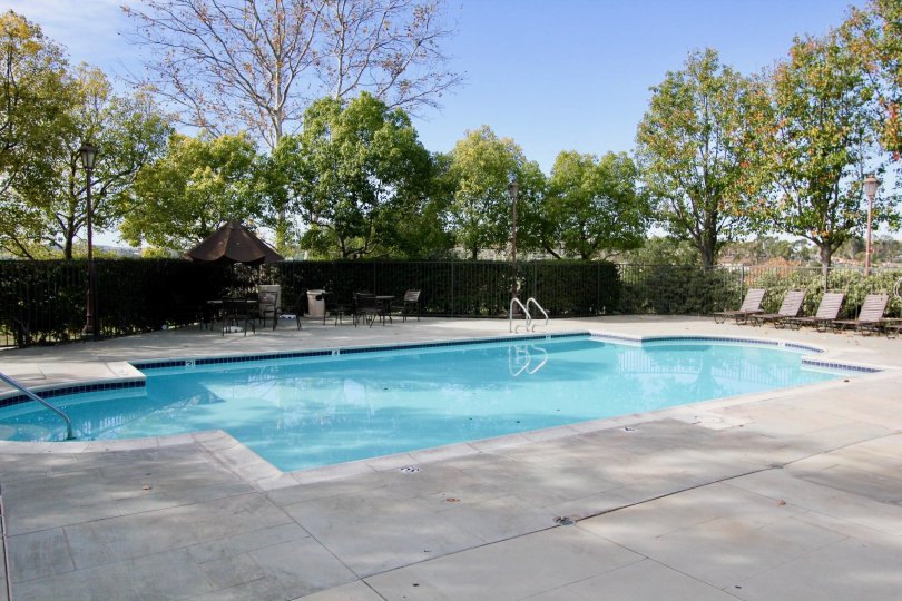 A blue color swimming pool under the clear sky in the Chambray.