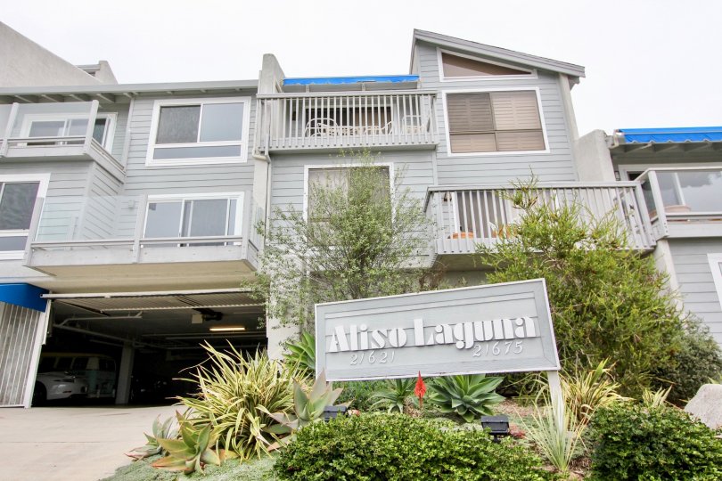 A sign that reads Aliso Laguna outside of a three story complex in Laguna Beach CA