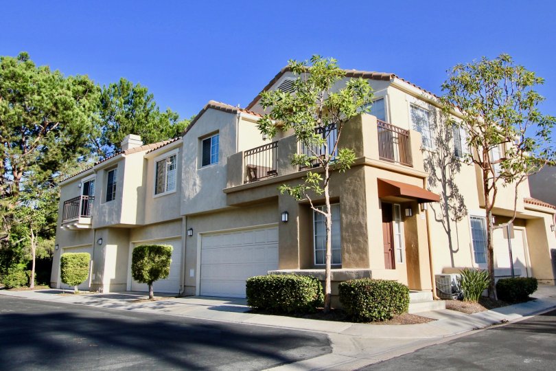 A tan building with three garages in Chandon community in Laguna Niguel, California.