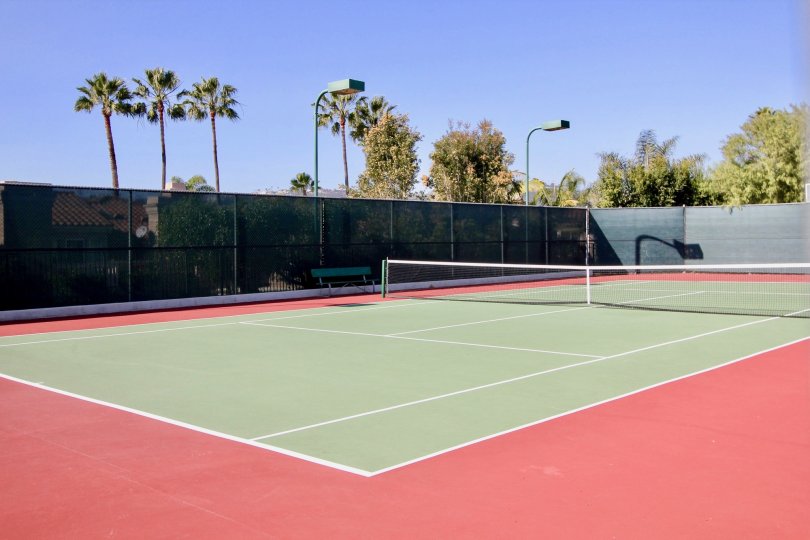 a sunny day in the le st. tropez with a play ground that has tennis court in it
