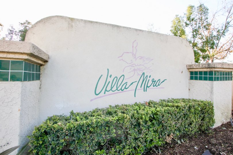 beautiful sunny day green hedges and Villa Mira sign in Villa Mira
