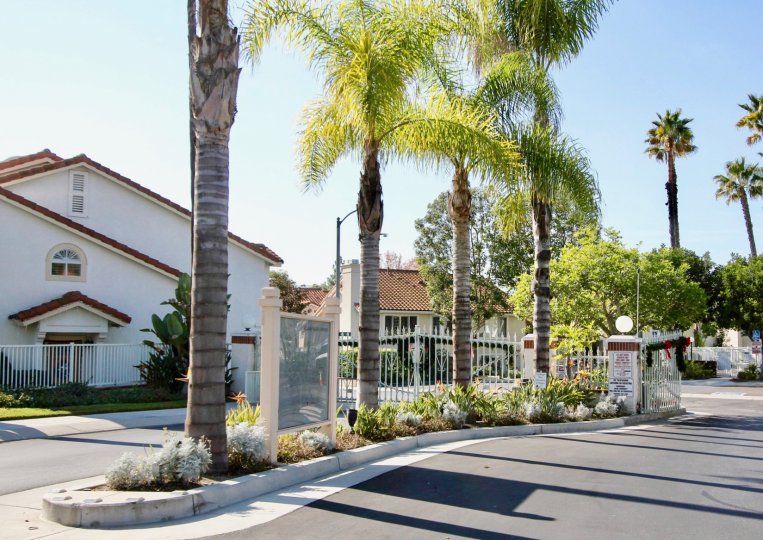 Trees and front gate at Village Niguel Gardens in Laguna Niguel, CA