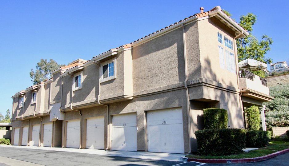 A building is situated nearby the road in the Village Niguel Terrace II.