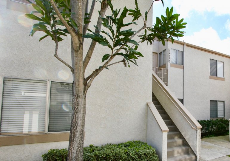 Side view of a white color house with an old type staircase