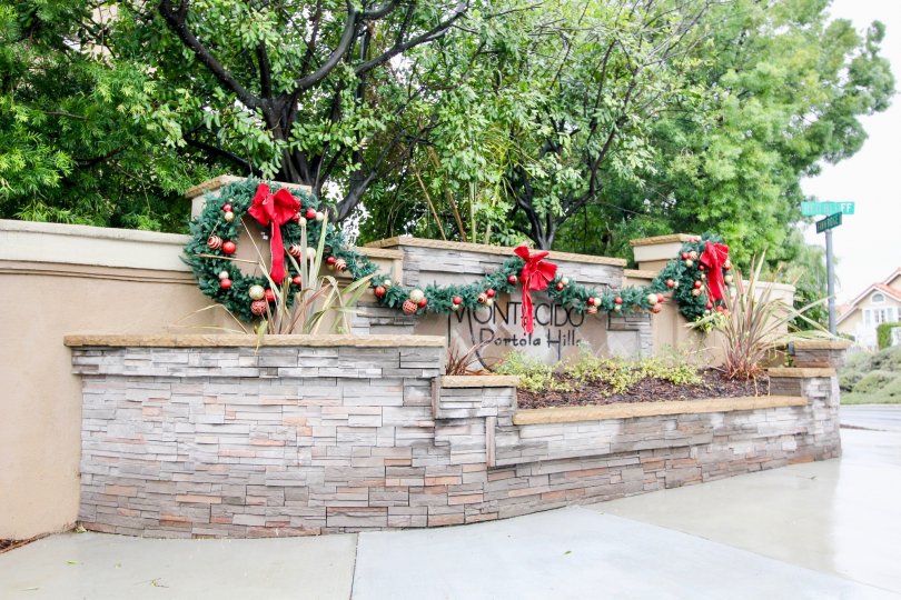 A stone wall with the name of the Montecido community on it in Lake Forest, California.