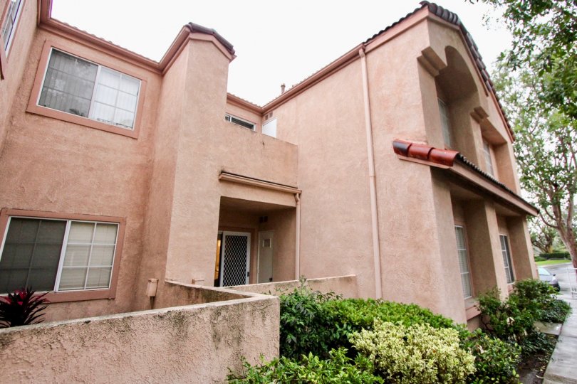 A cement pinkish tan home in Serrano Sandcastle community in Lake Forest, California.