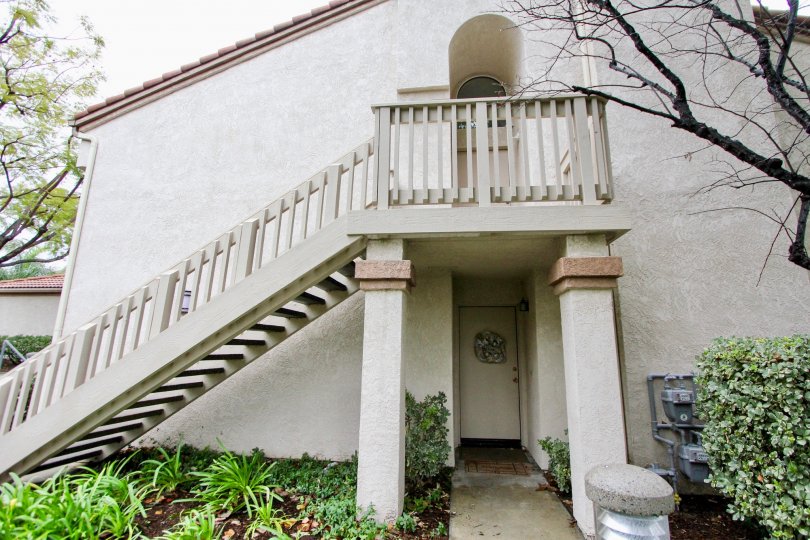 A stair case going up to a door and a door on the first floor in Villorio community in Lake forest, California.
