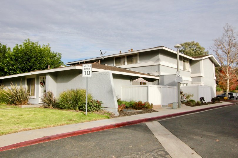 Grey color home with beautiful lawn and sloped roof in Aliso Villas.