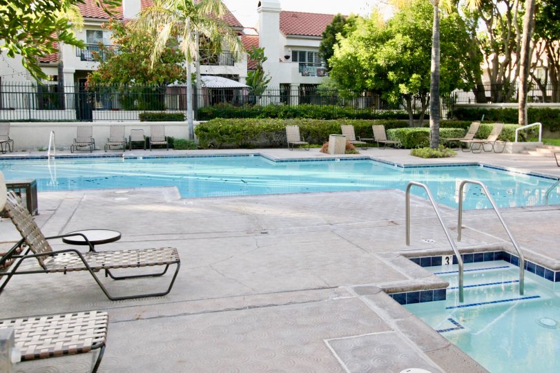 Double swimming pool with sun tan chairs in Coral Gardens.