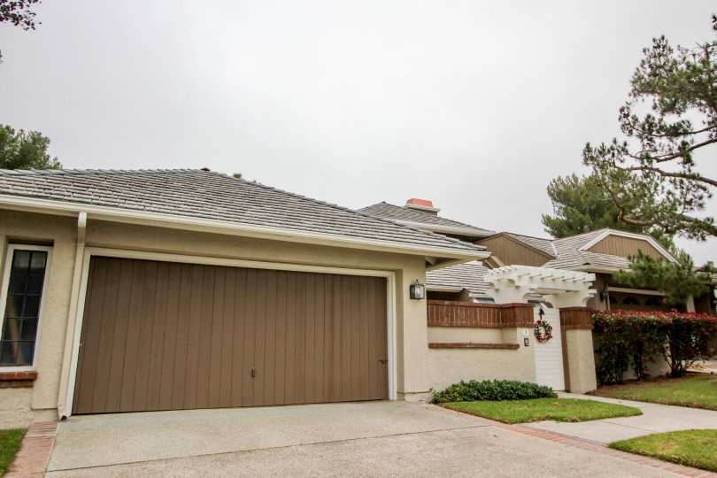 A large brown fence like garage door on a home in Harbor Ridge Crest in Newport Beach California