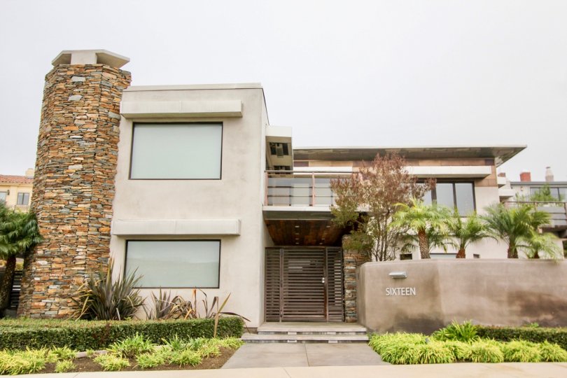 a warm day in the harbor ridge estates with building that has stone on chif top and named sixteen