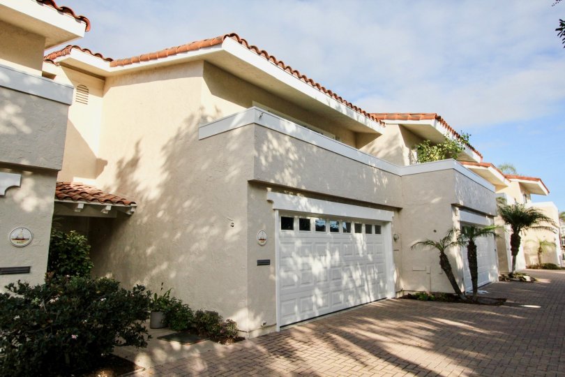 Sideview with garage door and open space of Newport Marina Villas community, Newport Beach, CA
