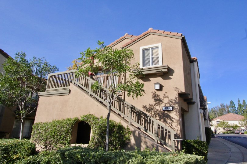 A beautiful big building and stairs in the Canyon Hills with a beautiful ornamental shrubs and trees.