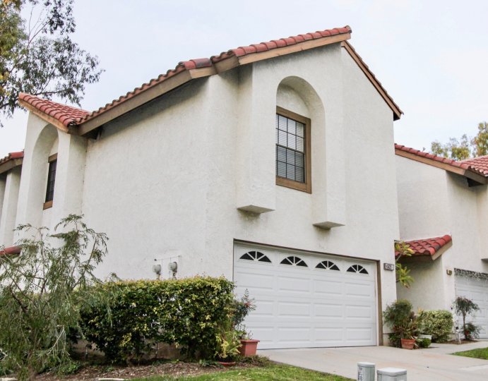 A white two story home in Villa la Paloma with a garage