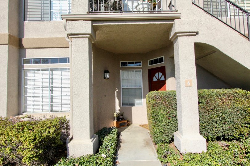 A sunny day in the area of Belflora, outside, condos, door, plants, stairs, windows, bushes